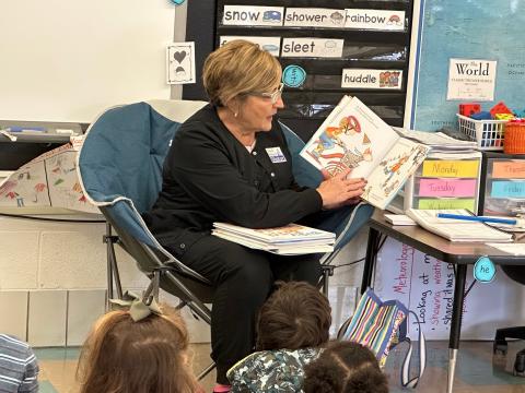 A volunteer reads to kindergarteners in Rootstown.